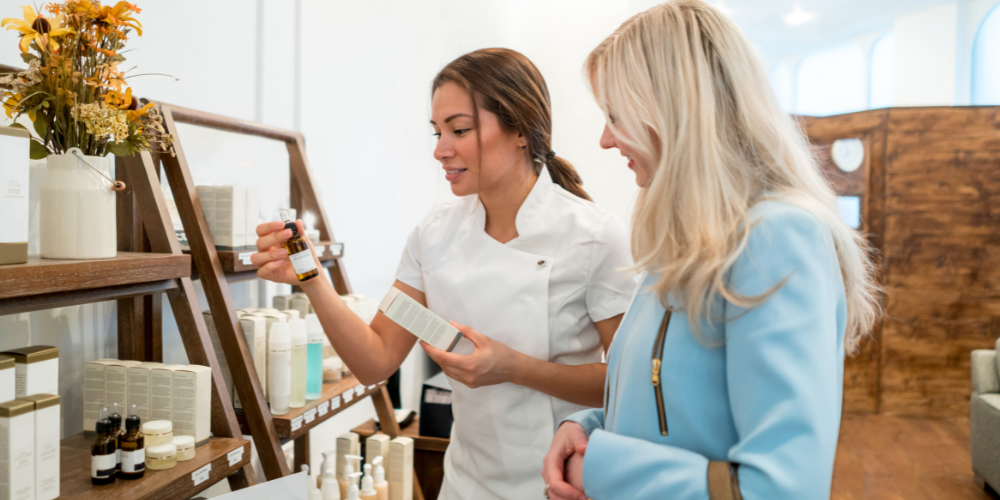 Professional sales assistant showcasing natural beauty products to a customer in an eco-friendly store. Perfect for organic skincare enthusiasts